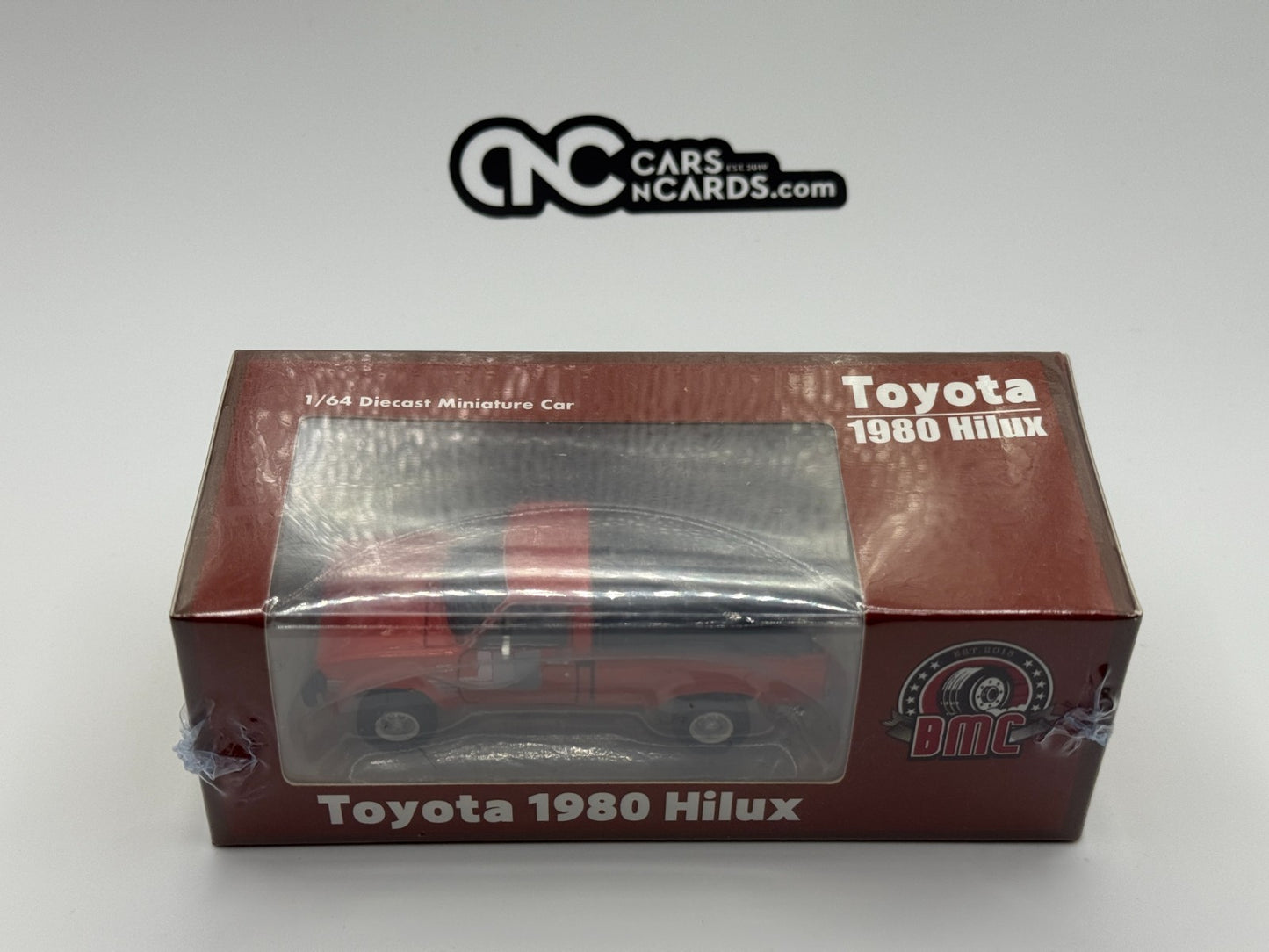 BMC 1:64 Toyota 1983 Hilux N60, N70 Orange RHD